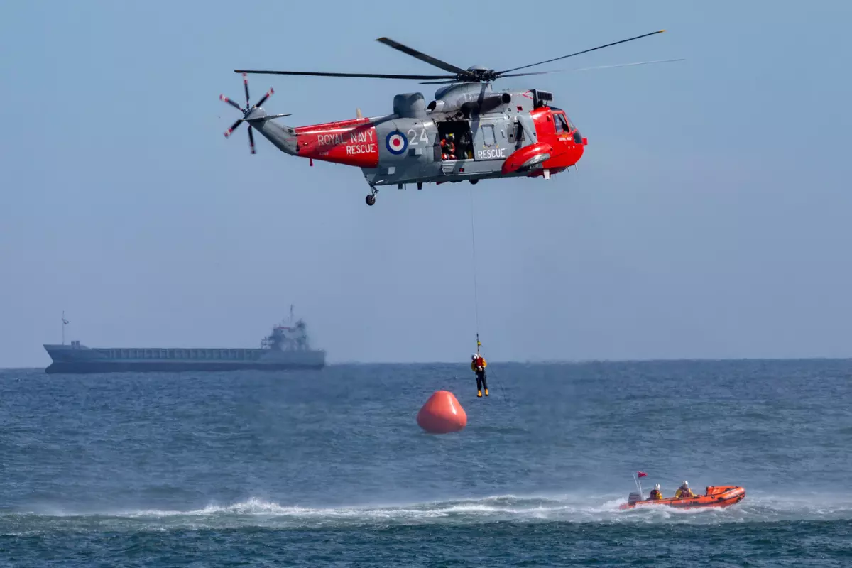 a helicopter and a cruise ship conducting a search and rescue operation