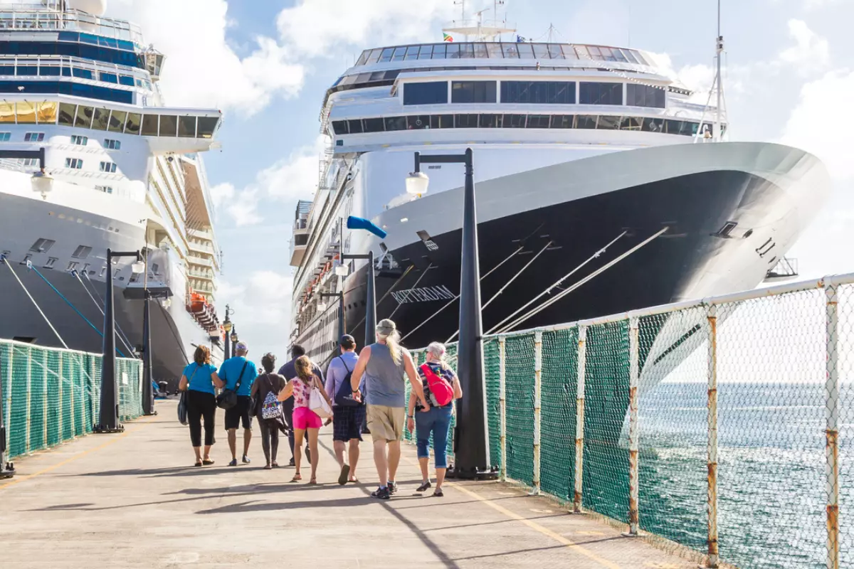 passengers running on a pier to board a cruise ship